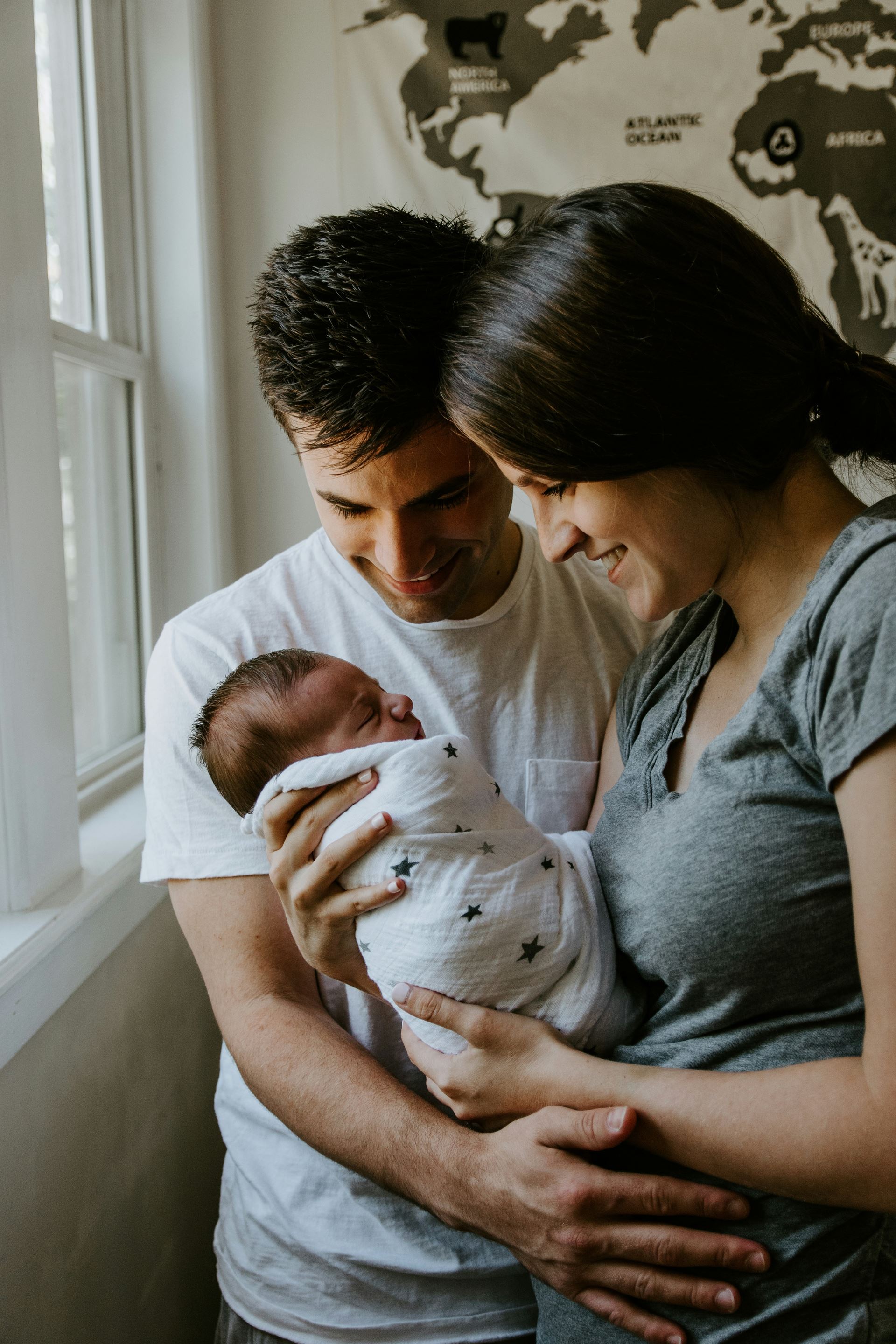 mother and father holding new born baby