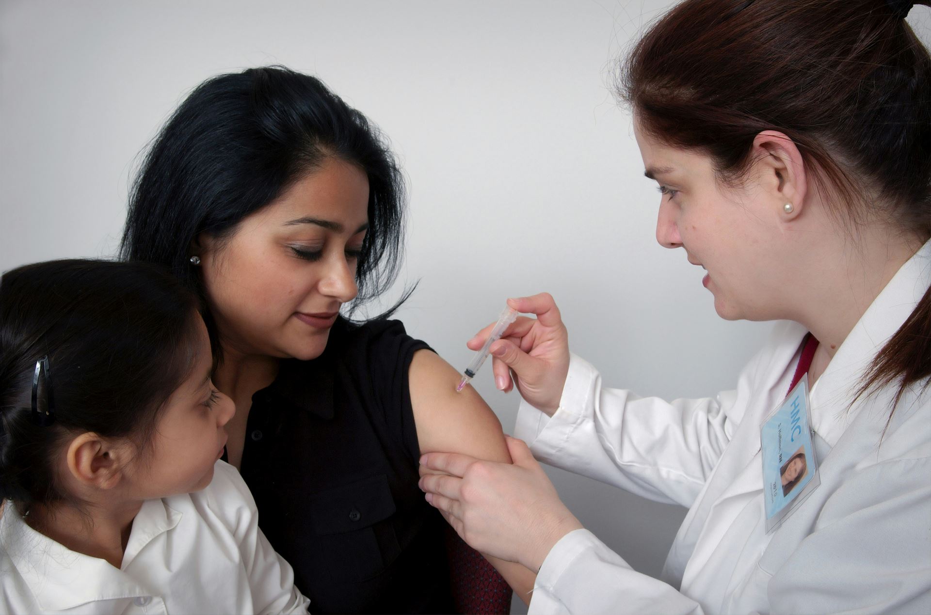 nurse giving jab to patient