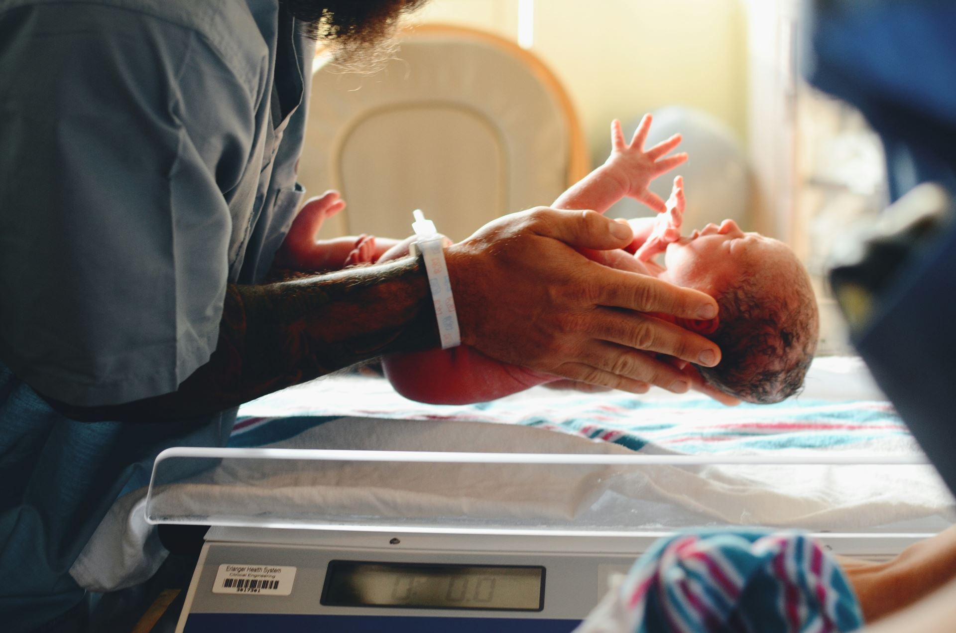 parent holding newborn baby